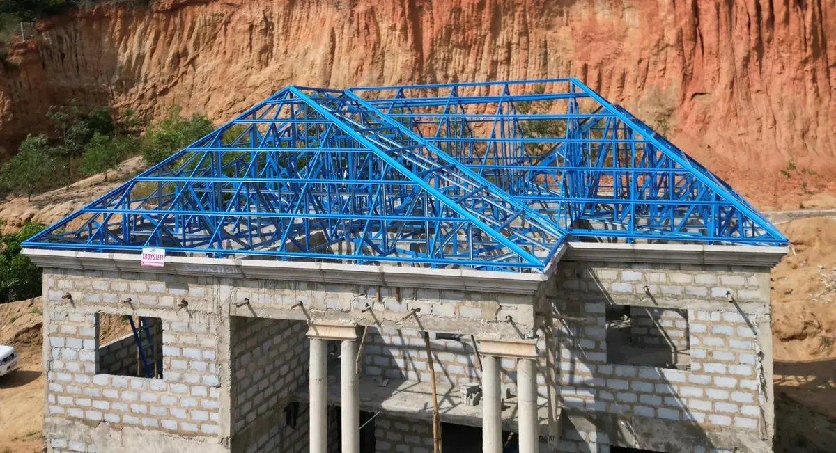 Blue steel roof trusses installed on a house