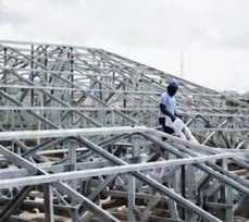 Worker installing light gauge steel trusses